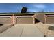 Row of garages featuring brick accents, concrete driveways, and solar panels on garage roof at 6921 S Bryant St, Littleton, CO 80120
