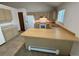 Bright kitchen with wood cabinets, laminate countertops, and an island with breakfast bar at 6921 S Bryant St, Littleton, CO 80120