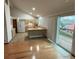 Open-concept view of living space with hardwood floors and sliding door to deck at 6921 S Bryant St, Littleton, CO 80120
