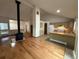 Spacious living area with hardwood floors, modern fireplace, and view to kitchen at 6921 S Bryant St, Littleton, CO 80120