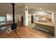 Inviting open-concept living space with hardwood floors, tall ceilings, fireplace, and a kitchen view at 6921 S Bryant St, Littleton, CO 80120