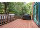 Wooden back deck with stairs, grill, and privacy wall surrounded by mature trees at 2445 W 39Th Ave, Denver, CO 80211