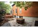 Backyard featuring brick exterior, deck, patio, and lush landscaping at 2445 W 39Th Ave, Denver, CO 80211