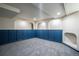 Finished basement featuring custom blue wainscoting, neutral walls, and plush gray carpet at 2445 W 39Th Ave, Denver, CO 80211
