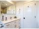 Bright bathroom with shaker cabinets, quartz countertop, framed mirror, and stylish decorative accents at 2445 W 39Th Ave, Denver, CO 80211