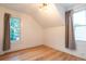 Cozy bedroom with hardwood floors, angled ceilings, ample natural light and neutral paint at 2445 W 39Th Ave, Denver, CO 80211