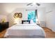 Cozy bedroom with ceiling fan, window with view, hardwood floors, and neutral decor at 2445 W 39Th Ave, Denver, CO 80211