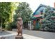 Exterior image featuring a wooden bear statue and a real estate sign in front of the home at 2445 W 39Th Ave, Denver, CO 80211