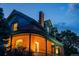 A beautiful red brick home exterior featuring detailed architecture, arched windows, and a classic chimney at 2445 W 39Th Ave, Denver, CO 80211
