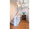 Bright foyer with hardwood floors, radiator, chandelier, and a staircase at 2445 W 39Th Ave, Denver, CO 80211