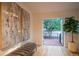 Hallway with a bench, modern art, hardwood floors, and a door to the outside deck at 2445 W 39Th Ave, Denver, CO 80211