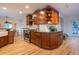 Kitchen featuring stainless steel appliances, tiled backsplash, wood cabinets, and hardwood floors at 2445 W 39Th Ave, Denver, CO 80211