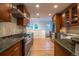 Spacious kitchen featuring updated appliances, wood cabinets, and hardwood floors at 2445 W 39Th Ave, Denver, CO 80211