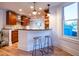 Modern kitchen with island seating, pendant lighting, wood cabinets, and hardwood floors at 2445 W 39Th Ave, Denver, CO 80211