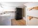 Basement laundry room featuring tile floor, washer, dryer, refrigerator, and open shelving at 2445 W 39Th Ave, Denver, CO 80211