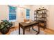 Bright home office space with wooden desk, modern shelving, natural light, and hardwood floors at 2445 W 39Th Ave, Denver, CO 80211