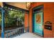 Covered front porch featuring a beautiful blue front door and classic brick facade at 2445 W 39Th Ave, Denver, CO 80211