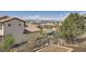 Landscaped backyard offering scenic views of the neighborhood and distant mountains at 9435 Winding Hill Way, Lone Tree, CO 80124