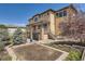 Spacious backyard with a well-manicured lawn, garden area, and stone patio, great for outdoor activities at 9435 Winding Hill Way, Lone Tree, CO 80124