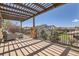 Relaxing covered balcony with outdoor seating and views of the landscaped backyard at 9435 Winding Hill Way, Lone Tree, CO 80124