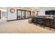 Spacious basement area featuring a built-in bar, sliding glass doors, and comfortable seating at 9435 Winding Hill Way, Lone Tree, CO 80124