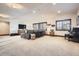 Expansive basement with seating area, large windows, providing natural light, and a piano at 9435 Winding Hill Way, Lone Tree, CO 80124
