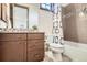 Stylish bathroom features brown wooden vanity and tiled shower/bath, complemented by neutral modern design at 9435 Winding Hill Way, Lone Tree, CO 80124