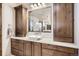 Bathroom with a large vanity, white countertops, and custom wood cabinets at 9435 Winding Hill Way, Lone Tree, CO 80124