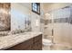 Elegant bathroom featuring granite countertop, glass shower, and sophisticated tile work at 9435 Winding Hill Way, Lone Tree, CO 80124