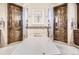 Spa-like bathroom with a soaking tub, dual glass door showers, and designer tile accents at 9435 Winding Hill Way, Lone Tree, CO 80124