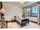 Cozy bedroom with carpet flooring, a single bed, a side table, and window views at 9435 Winding Hill Way, Lone Tree, CO 80124