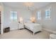 Bright bedroom with three windows, a white bed and nightstand, and a chandelier at 9435 Winding Hill Way, Lone Tree, CO 80124