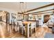 Bright dining room featuring wood floors, beam ceilings, a modern table, and lighting fixtures at 9435 Winding Hill Way, Lone Tree, CO 80124
