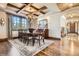 Spacious dining room with beamed ceilings, large windows, and hardwood floors at 9435 Winding Hill Way, Lone Tree, CO 80124