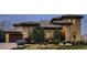 Stunning stone home featuring a tile roof, landscaped yard, and charming curb appeal at 9435 Winding Hill Way, Lone Tree, CO 80124