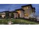 Beautiful home exterior showcasing the stone facade, manicured lawn, and architectural details at 9435 Winding Hill Way, Lone Tree, CO 80124