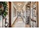Inviting hallway featuring a brick barrel ceiling, wood floors, and ample natural light at 9435 Winding Hill Way, Lone Tree, CO 80124