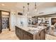 Open-concept kitchen featuring a center island, stainless steel appliances, and custom cabinets at 9435 Winding Hill Way, Lone Tree, CO 80124