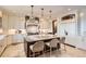 Well-appointed kitchen featuring granite counters, a center island, and custom lighting at 9435 Winding Hill Way, Lone Tree, CO 80124