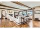 Bright living room featuring wood floors, beam ceilings, a fireplace, and plentiful windows at 9435 Winding Hill Way, Lone Tree, CO 80124