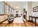 Inviting living room featuring hardwood floors, a fireplace, and window seating with custom wooden blinds at 9435 Winding Hill Way, Lone Tree, CO 80124