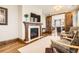 Comfortable living room with a fireplace, TV, and wood trim at 9435 Winding Hill Way, Lone Tree, CO 80124