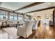 Bright living room featuring hardwood floors, beamed ceilings, views, and comfortable seating at 9435 Winding Hill Way, Lone Tree, CO 80124