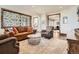 Comfortable living room with wood floors, plush rug, and decorative iron screen at 9435 Winding Hill Way, Lone Tree, CO 80124