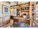 Elegant home office with custom built-ins, wood trim, and a spacious desk at 9435 Winding Hill Way, Lone Tree, CO 80124