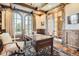 Bright office space with coffered ceilings, large windows, and an ornate area rug at 9435 Winding Hill Way, Lone Tree, CO 80124