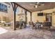 Covered outdoor living space complete with a fireplace, ceiling fan, and comfortable seating area at 9435 Winding Hill Way, Lone Tree, CO 80124