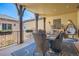 Inviting covered patio with outdoor dining set and comfortable seating, perfect for entertaining at 9435 Winding Hill Way, Lone Tree, CO 80124