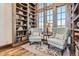 Charming sitting area with a large bookcase, wood floors, and comfortable seating at 9435 Winding Hill Way, Lone Tree, CO 80124