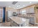 Kitchen with gray cabinets, stainless steel appliances, and an island at 12077 Ivy Ct, Brighton, CO 80602